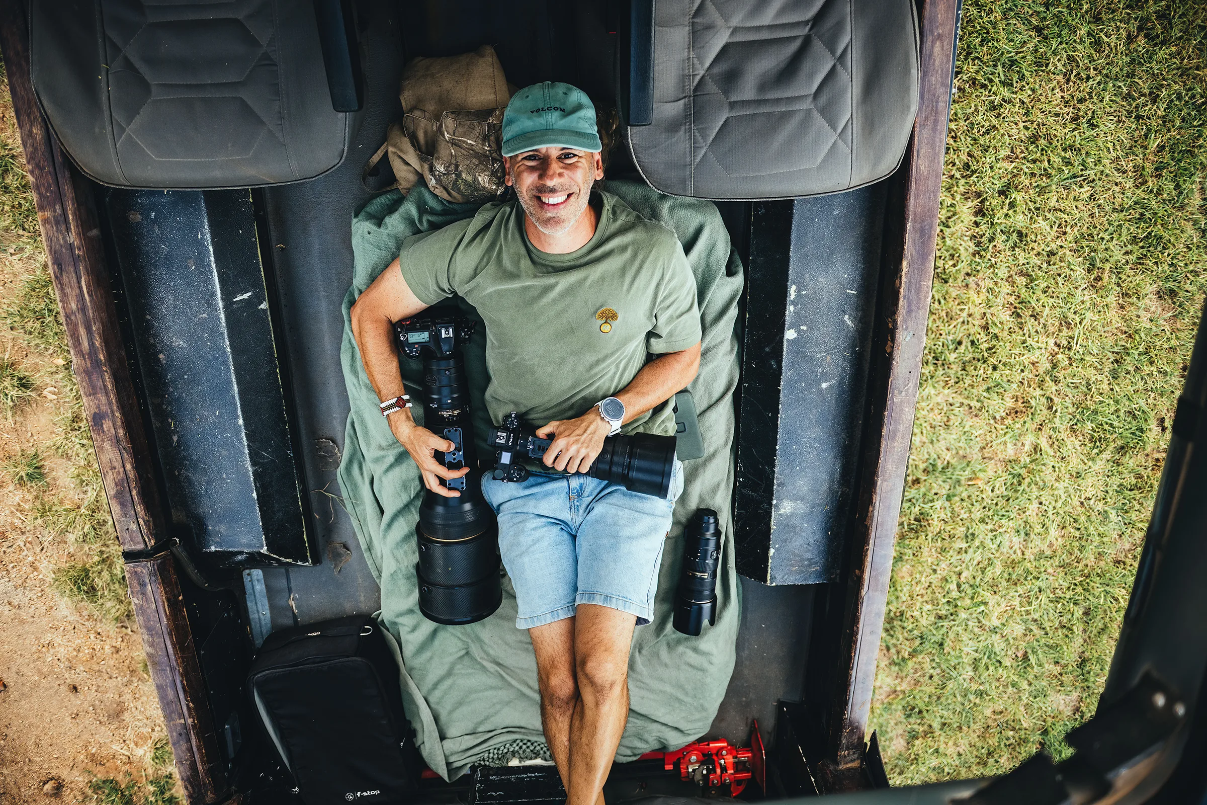 Nando Morales wildlife photographer holding a camera during a safari in Africa